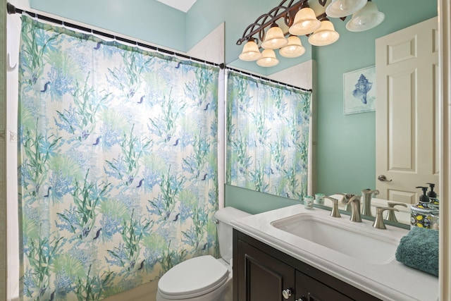 bathroom featuring a shower with curtain, toilet, and vanity