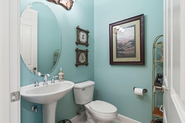 bathroom featuring toilet and baseboards