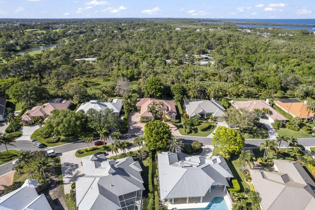 birds eye view of property featuring a residential view, a wooded view, and a water view