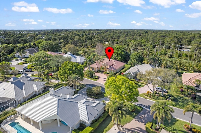 bird's eye view with a wooded view and a residential view