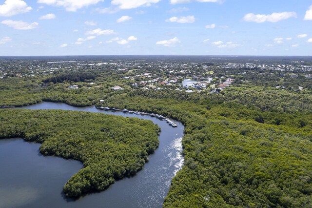 aerial view featuring a water view and a wooded view