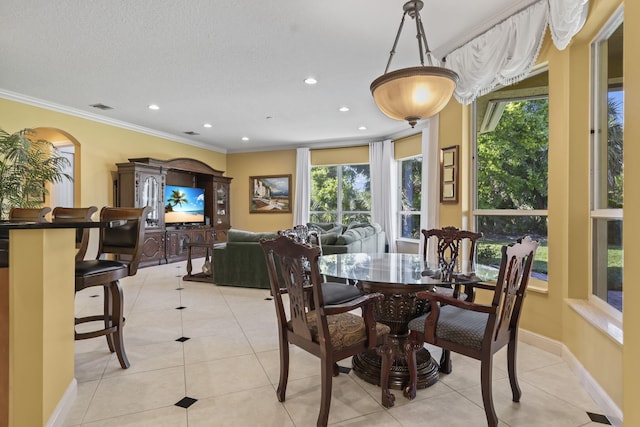 dining room with light tile patterned floors, recessed lighting, crown molding, and baseboards