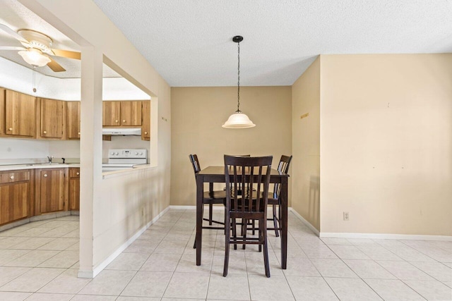 dining area with a ceiling fan, baseboards, a textured ceiling, and light tile patterned flooring