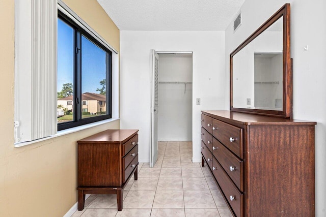 walk in closet with light tile patterned floors and visible vents