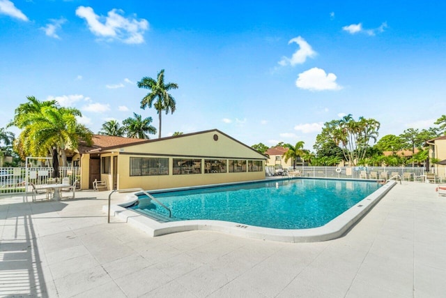 pool featuring a patio area and fence