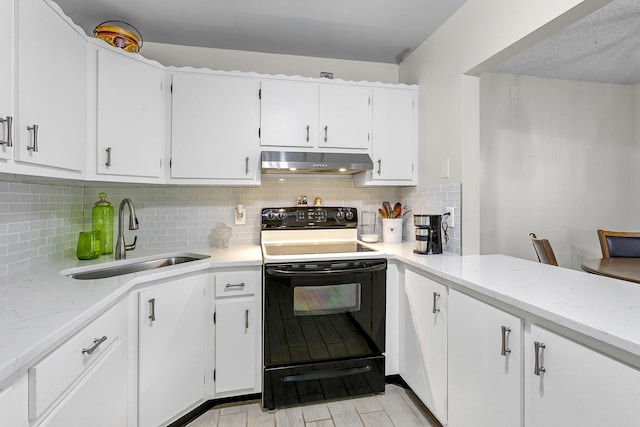 kitchen featuring tasteful backsplash, electric range, white cabinetry, a sink, and under cabinet range hood