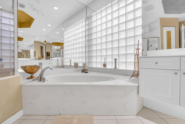 full bathroom featuring vanity, visible vents, a shower stall, a bath, and tile patterned floors