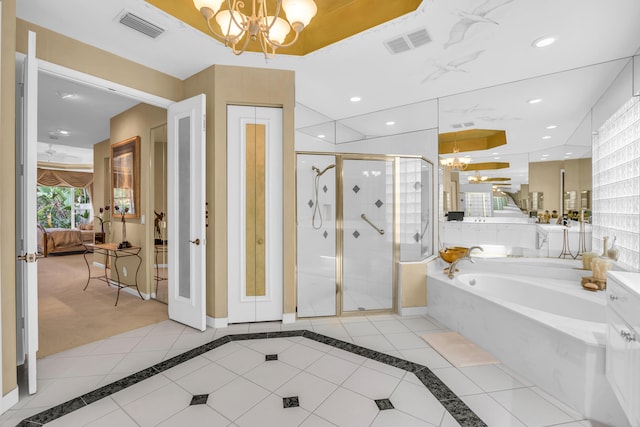 ensuite bathroom featuring visible vents, a notable chandelier, and recessed lighting