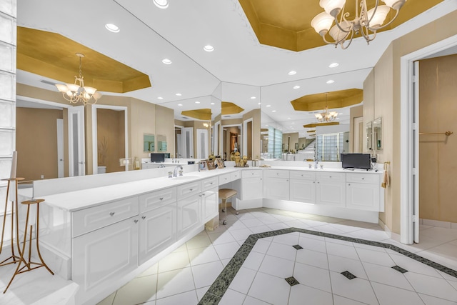 full bathroom with tile patterned flooring, a tray ceiling, a notable chandelier, and recessed lighting