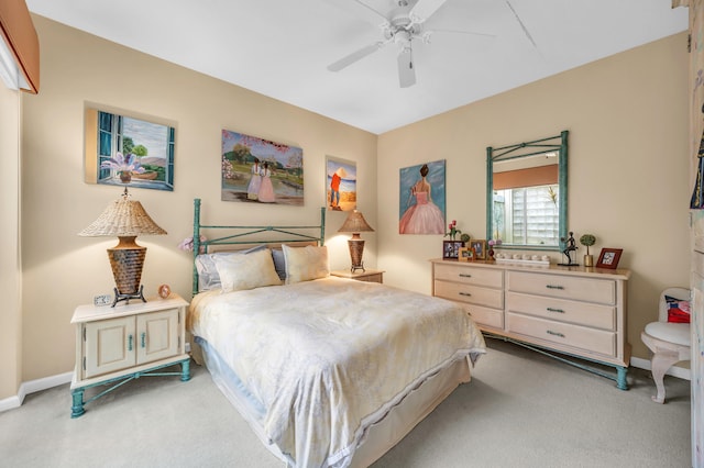 bedroom featuring ceiling fan, baseboards, and light colored carpet