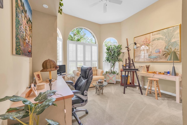 carpeted home office featuring a ceiling fan and baseboards