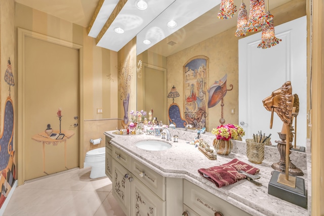 bathroom with tile patterned flooring, vanity, and toilet