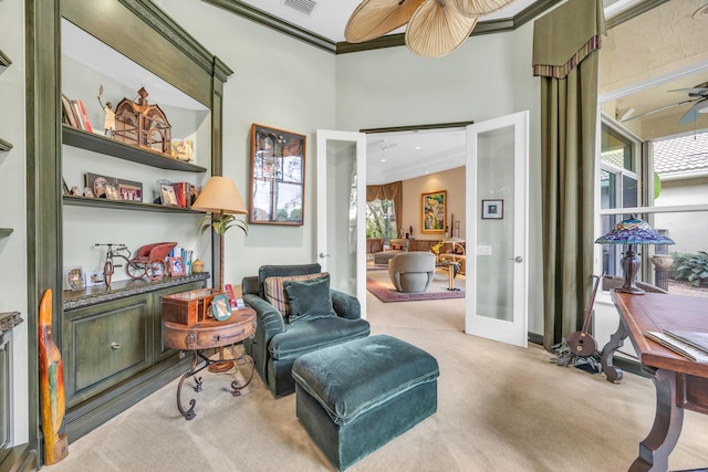 living area with crown molding, french doors, a healthy amount of sunlight, and ceiling fan