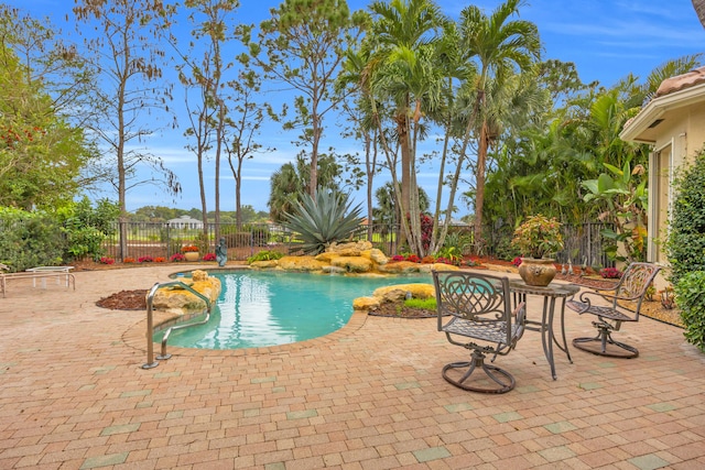 view of pool featuring a patio, a fenced backyard, and a fenced in pool