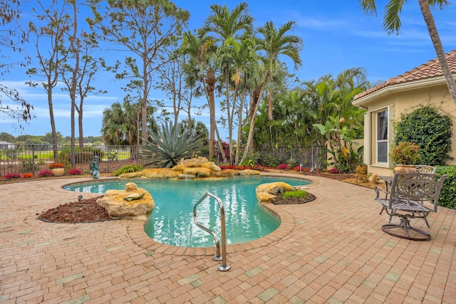 view of swimming pool featuring a fenced in pool, a patio area, and fence