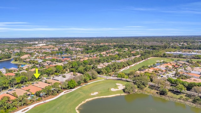 birds eye view of property featuring view of golf course, a water view, and a residential view