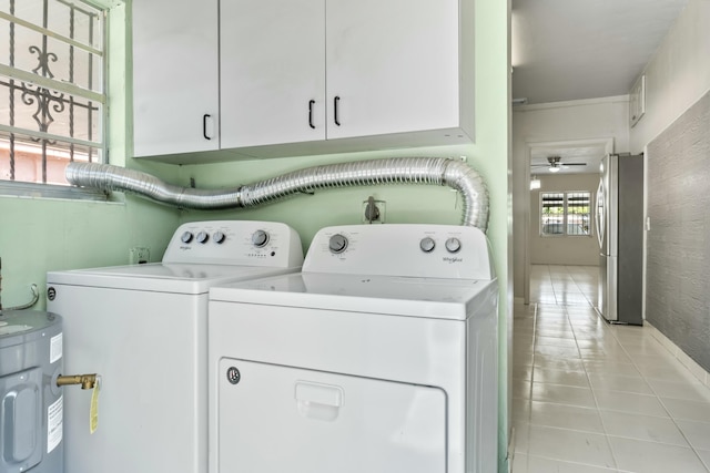 clothes washing area with washer and clothes dryer, light tile patterned floors, water heater, cabinet space, and a ceiling fan