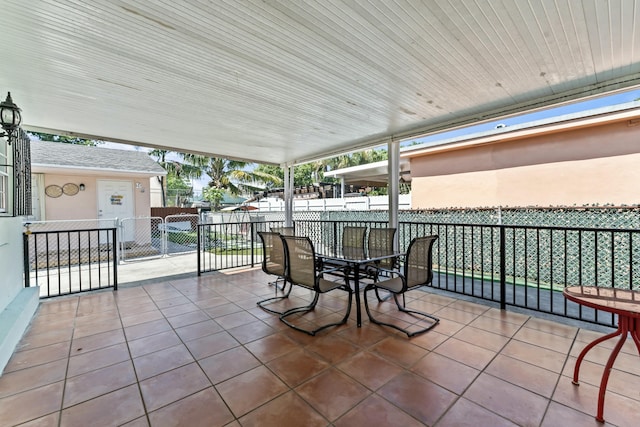 view of patio featuring outdoor dining space and fence