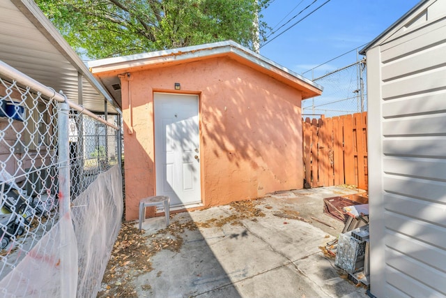 exterior space featuring an outdoor structure and fence