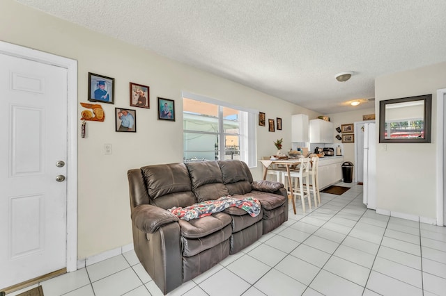 living room featuring a textured ceiling and light tile patterned flooring