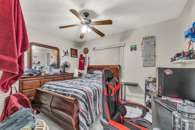 tiled bedroom with a textured ceiling and ceiling fan