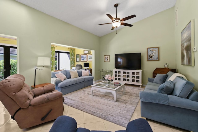 living room with tile patterned flooring, vaulted ceiling, and ceiling fan