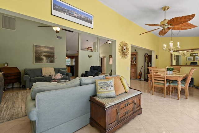 living area featuring light tile patterned floors, visible vents, and ceiling fan with notable chandelier