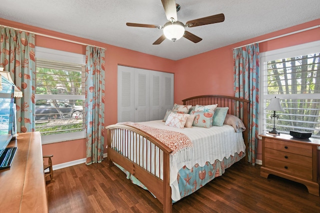 bedroom featuring a closet, multiple windows, and wood finished floors