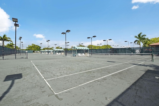 view of tennis court featuring fence