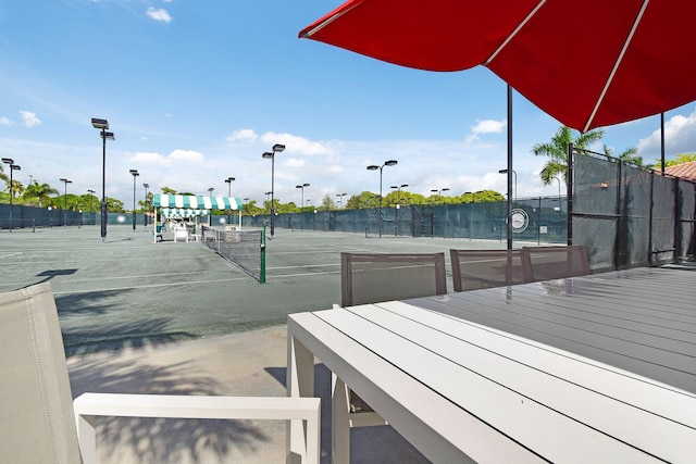 view of sport court featuring fence