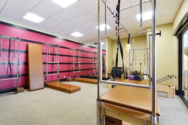 carpeted office featuring a paneled ceiling