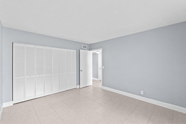 unfurnished bedroom featuring visible vents, baseboards, and tile patterned floors