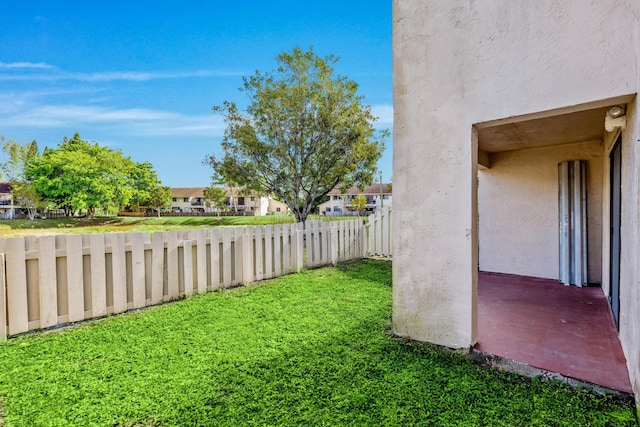 view of yard featuring fence and a residential view