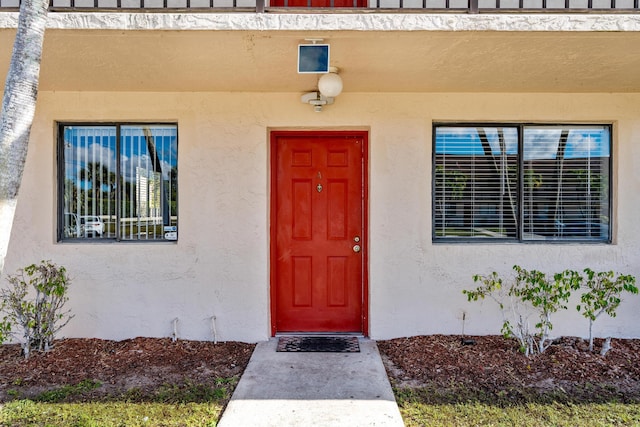 property entrance with stucco siding