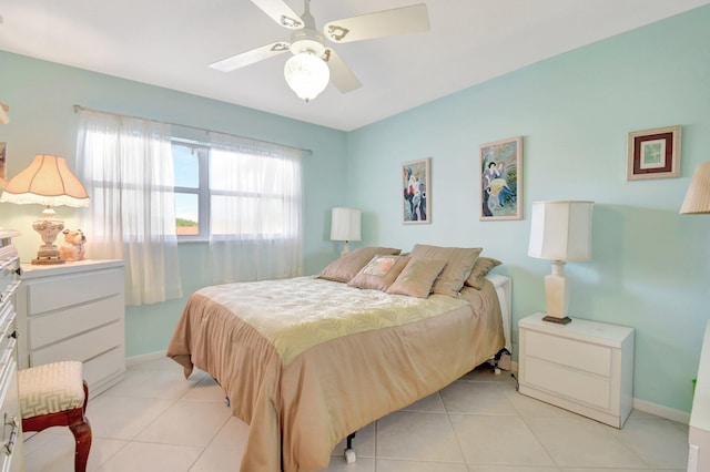 bedroom featuring a ceiling fan, light tile patterned flooring, and baseboards