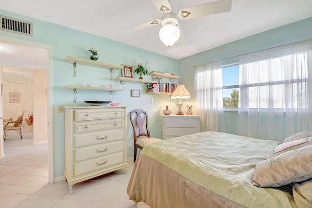 bedroom with light tile patterned floors, visible vents, and a ceiling fan