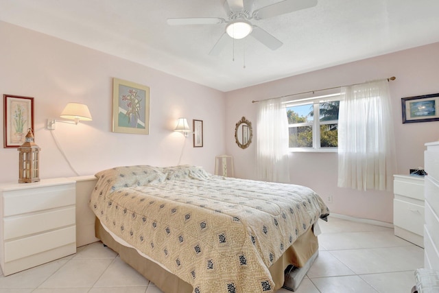 bedroom with a ceiling fan, light tile patterned flooring, and baseboards