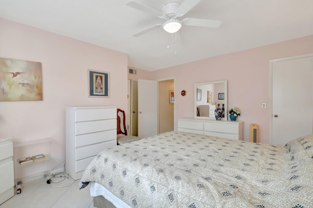 bedroom featuring a ceiling fan, visible vents, and light tile patterned floors