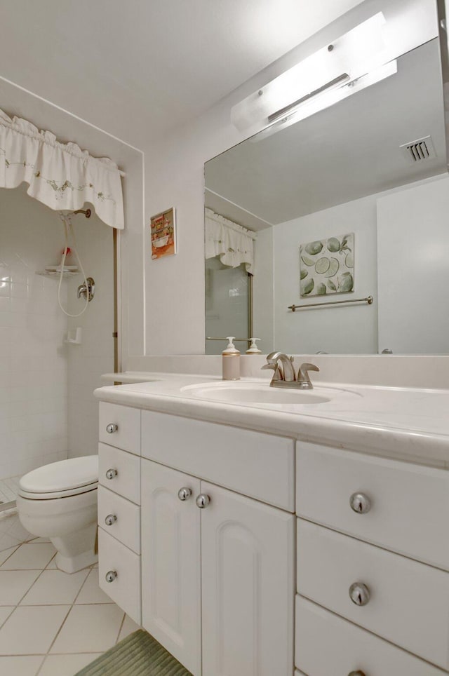 bathroom with a shower, visible vents, toilet, vanity, and tile patterned flooring