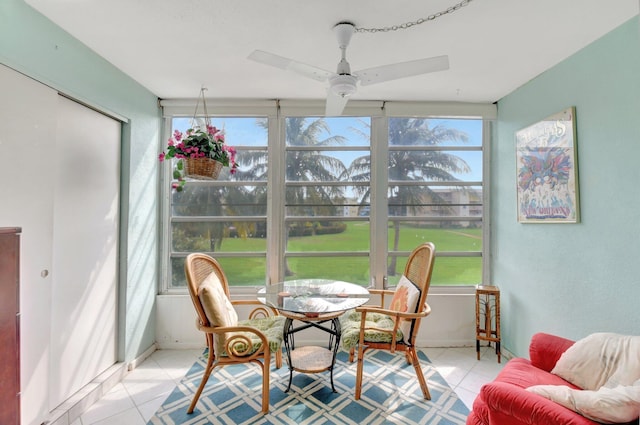 sunroom featuring ceiling fan and plenty of natural light