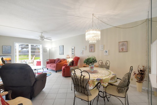 dining room with ceiling fan with notable chandelier and light tile patterned flooring