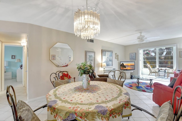 dining room featuring light tile patterned floors, visible vents, and ceiling fan with notable chandelier