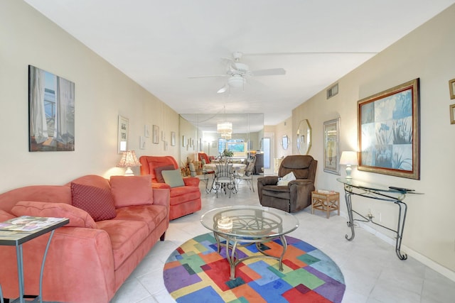 living area with ceiling fan, visible vents, and baseboards