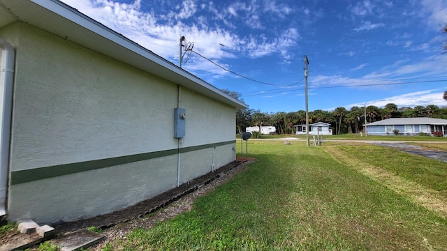 view of property exterior featuring a lawn and stucco siding