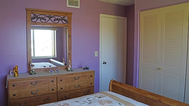 bedroom featuring a closet and visible vents