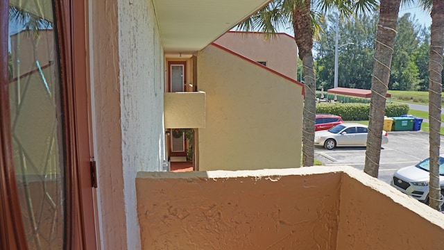 details featuring a parking lot and stucco siding