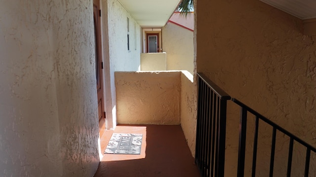 hallway featuring a textured wall