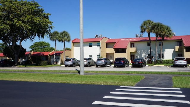 view of building exterior with uncovered parking