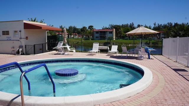 view of swimming pool with a patio area, fence, and a pool