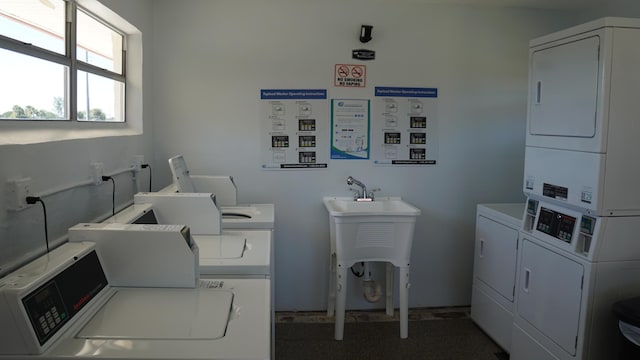 community laundry room with washer and dryer and stacked washer and clothes dryer